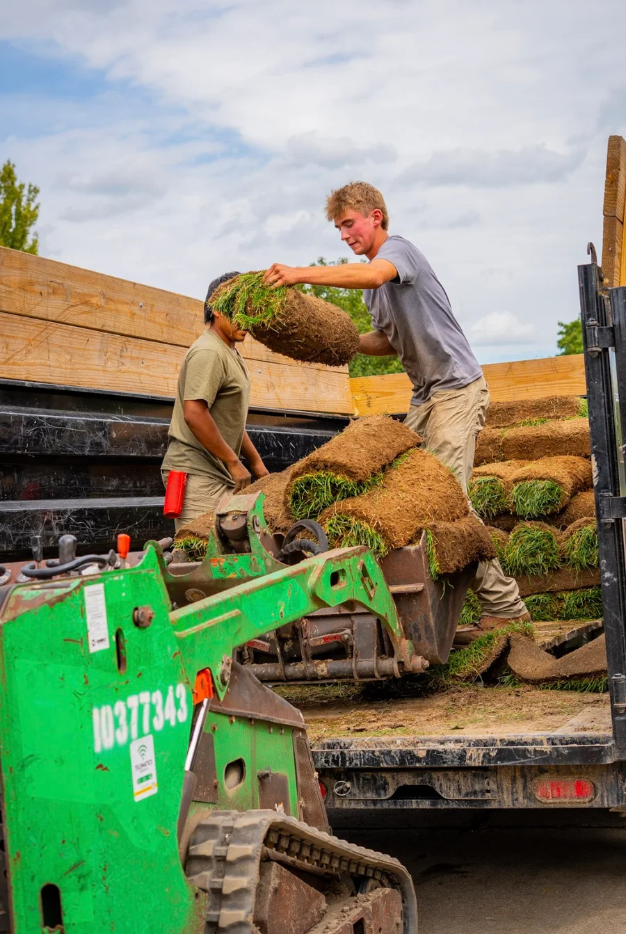 DR crew working together to move sod from the truck
